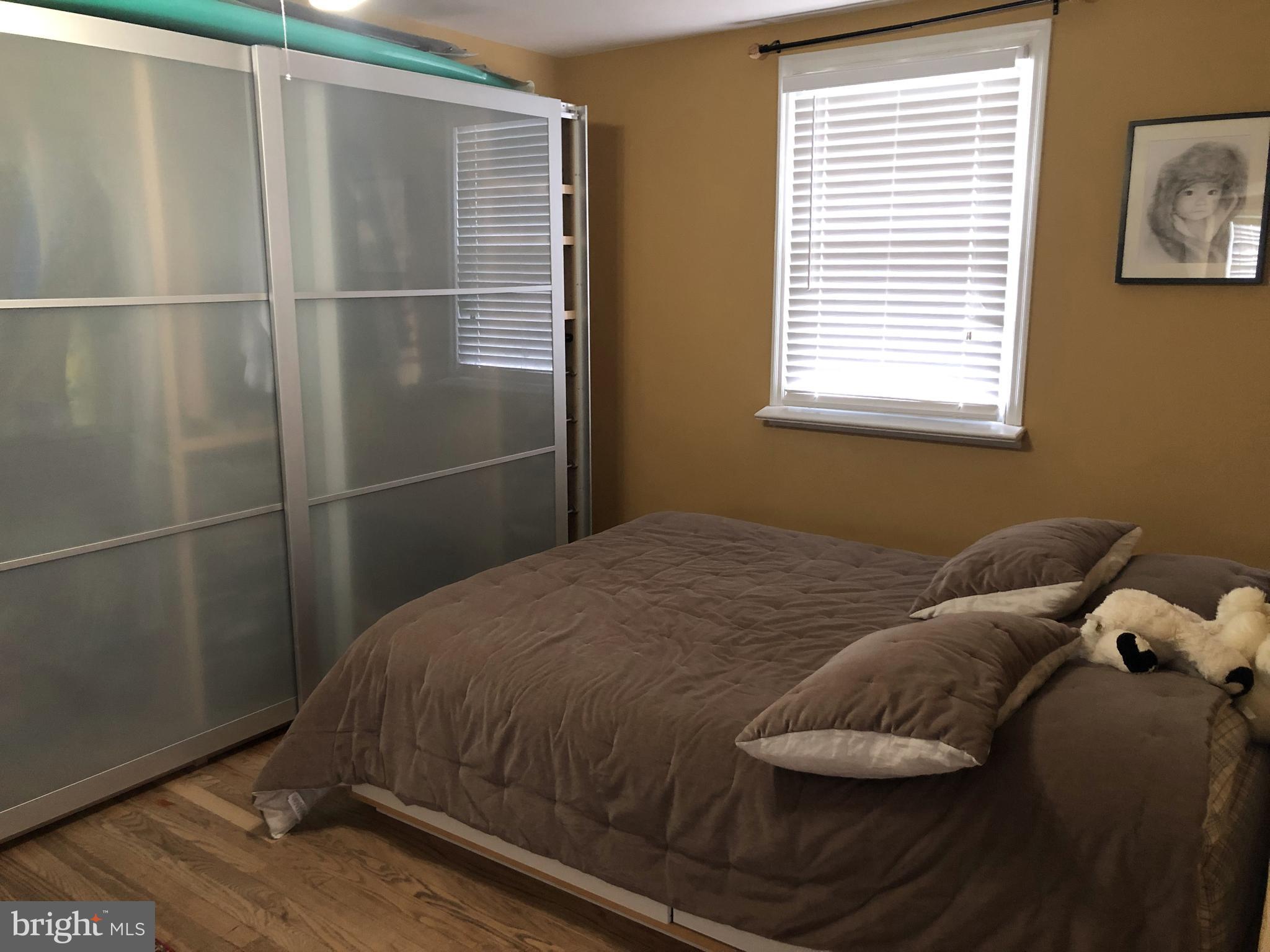 10119 Greeley Avenue Silver Spring, MD 20902 - Photo 7 of 13 a bedroom with a bed and a window