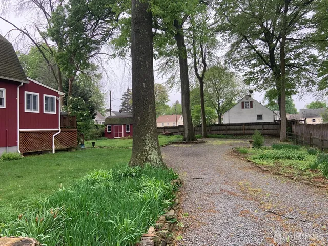 a front view of a house with a garden and deck