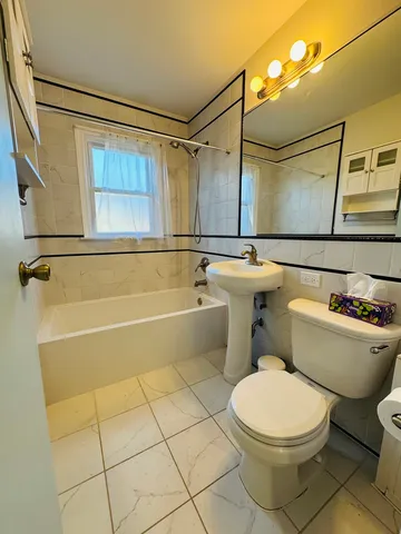 a bathroom with a toilet a sink and a shower