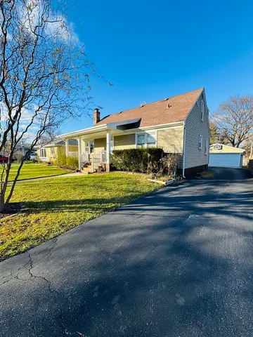 a front view of a building with a yard