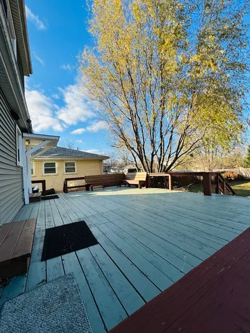 a view of a house with wooden deck