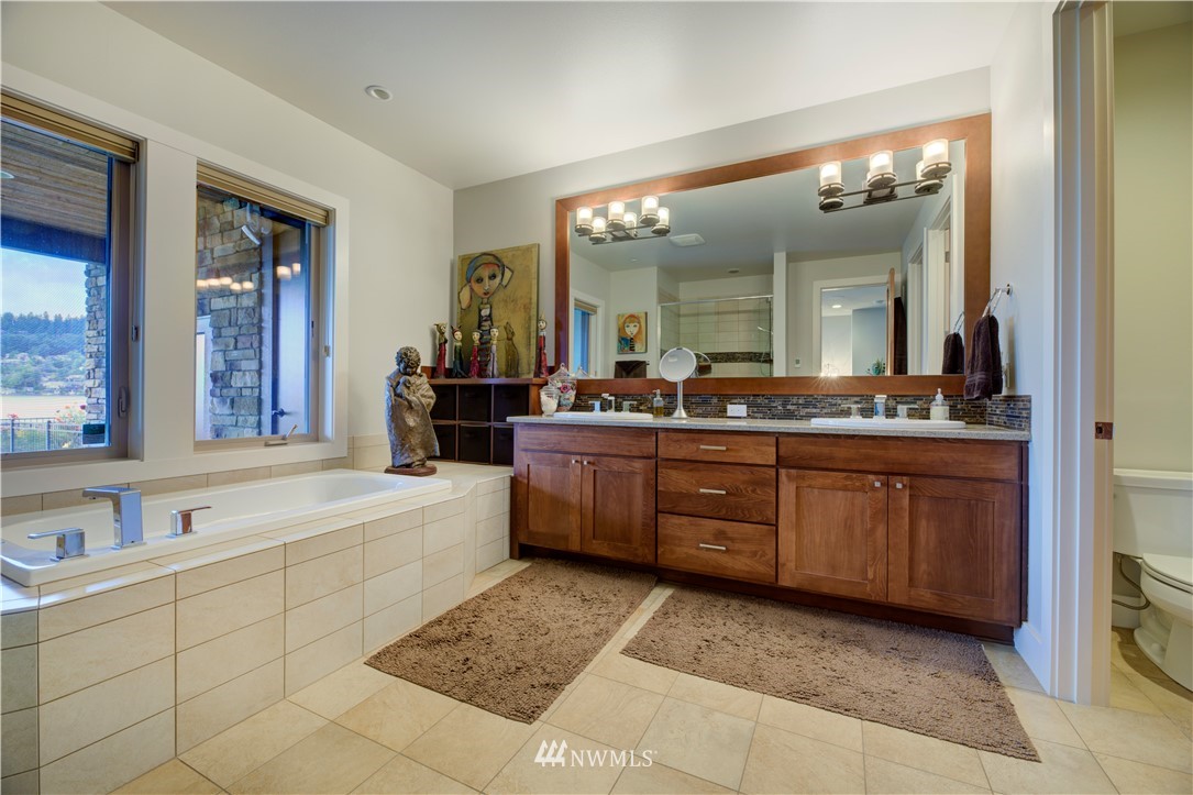 4169 Williams Avenue North Renton, WA 98056 - Photo 13 of 35 a spacious bathroom with a granite countertop tub sink and mirror
