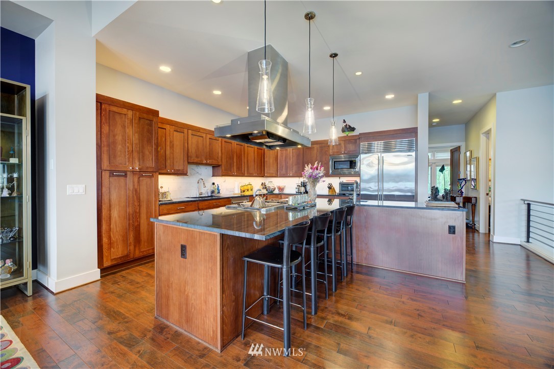 4169 Williams Avenue North Renton, WA 98056 - Photo 4 of 35 a kitchen with stainless steel appliances kitchen island granite countertop a table chairs and a refrigerator