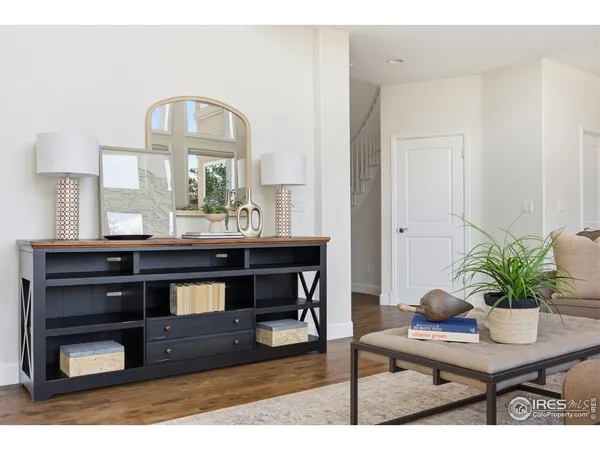 a living room with furniture a large window and a fireplace