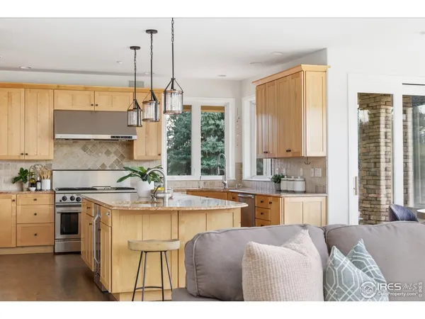 a kitchen with stainless steel appliances granite countertop a sink a stove and a microwave