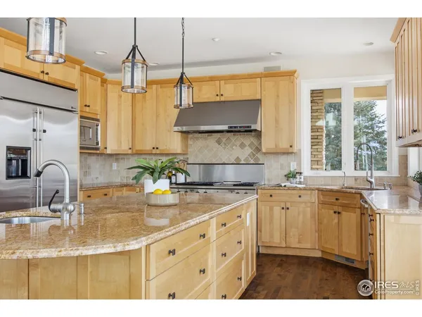 a kitchen with a stove a sink and cabinets