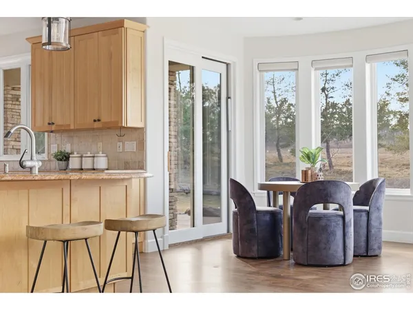 a dining room with furniture and wooden floor