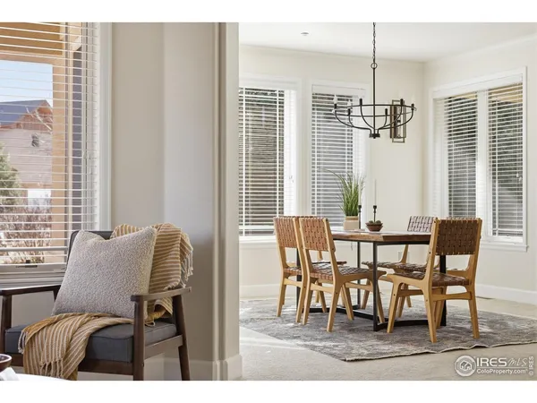 a dining room with furniture a chandelier and window