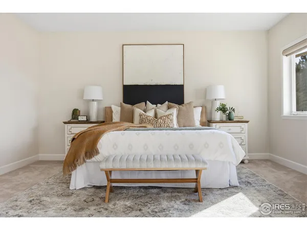 a bedroom with a bed and a lamp