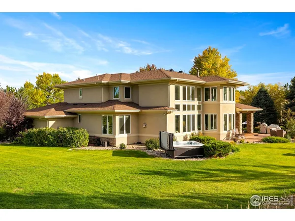 a front view of a house with a garden and sitting area