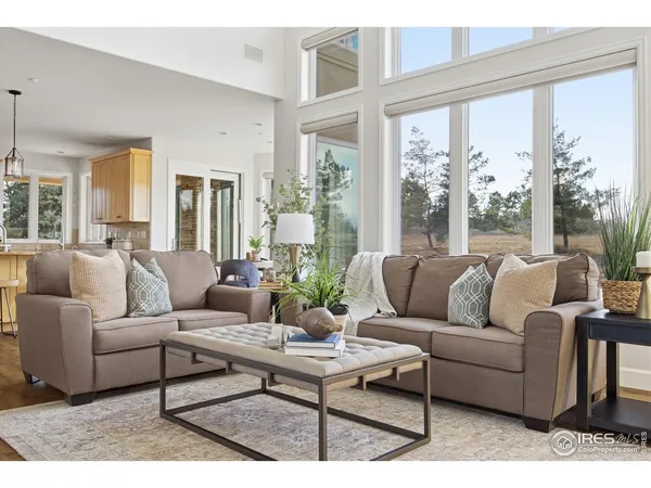 a living room with furniture a table and a fireplace