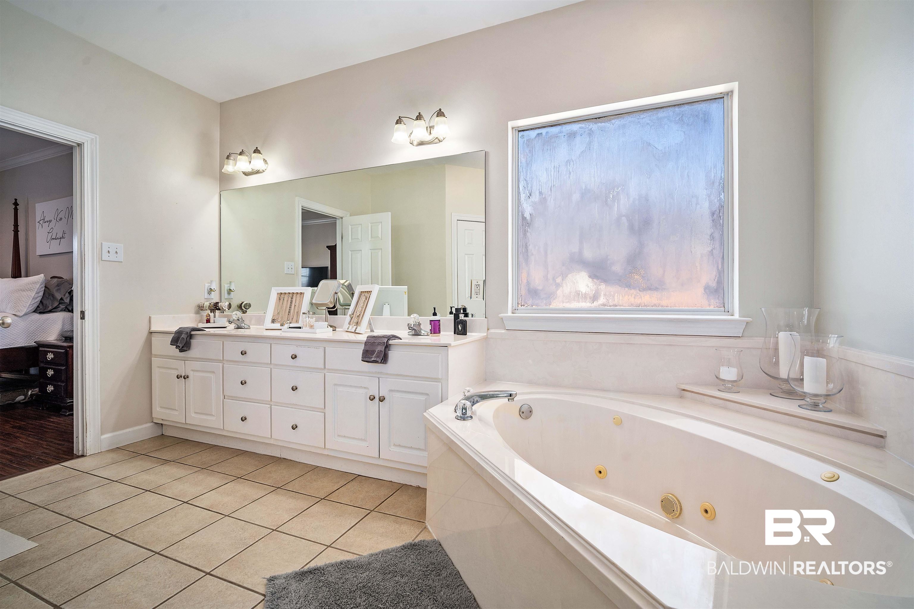 9552 White Castle Road Mobile, AL 36695 - Photo 19 of 31 Ensuite bathroom with double vanity, tile floors, a tub with jets