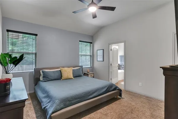 a bedroom with a large bed and a chandelier