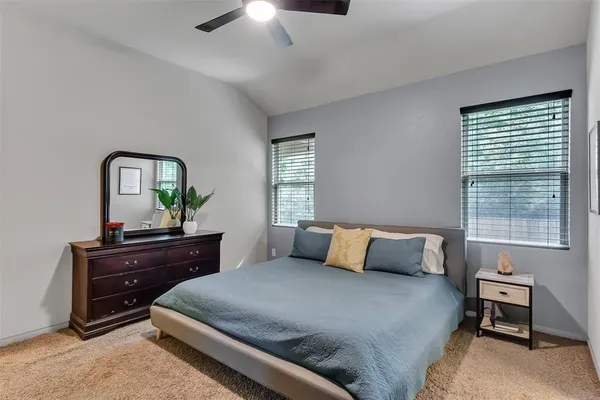 a bedroom with a bed window and lamps