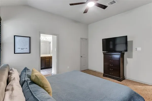 a bedroom with furniture and a flat screen tv