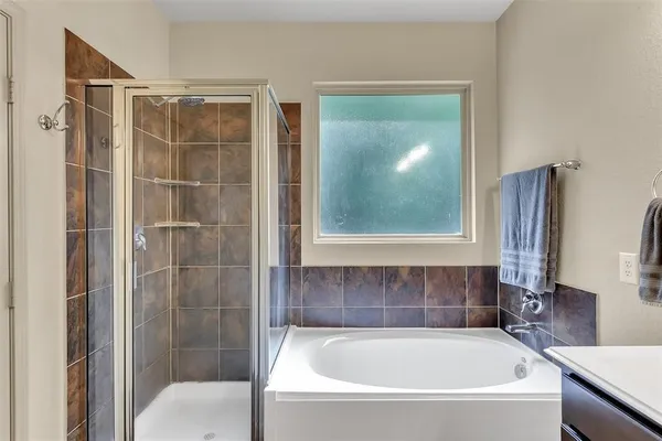 a bathroom with a bathtub and a shower