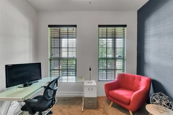 a view of a livingroom with workspace and a window