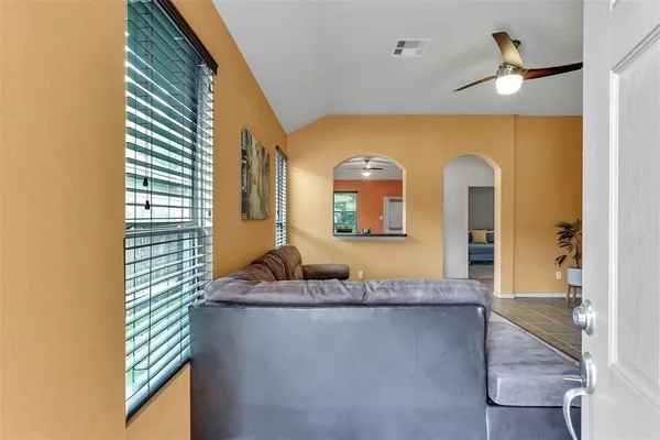 a en suite bathroom with a granite countertop sink and a mirror