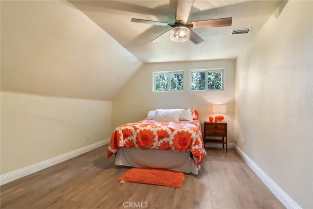 a bedroom with a bed and a ceiling fan