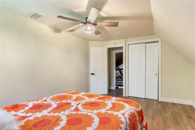 a bedroom with a large bed and a chandelier
