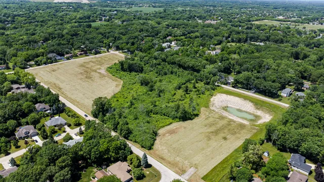 an aerial view of a house with a yard and outdoor seating