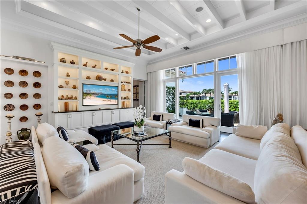 2157 Asti Court Naples, FL 34105 - Photo 11 of 29 The great room also has automated sun shades to bring calm and coolness to the interiors.
