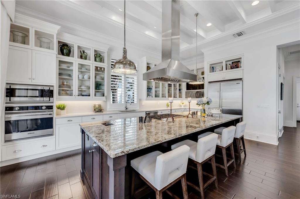 2157 Asti Court Naples, FL 34105 - Photo 13 of 29 Thoughtful details for the culinary enthusiast, including integrated knife storage and a discreet countertop chute.