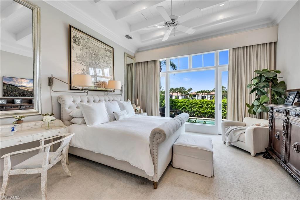 2157 Asti Court Naples, FL 34105 - Photo 14 of 29 Owner's Suite is spacious, yet cozy-feeling, with beautiful views and French doors out to the pool.