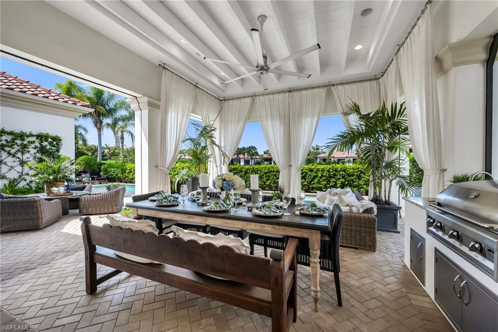 2157 Asti Court Naples, FL 34105 - Photo 4 of 29 Imaging entertaining and relaxing in this chic yet cozy, screened-in lanai, with fabulous outdoor kitchen!