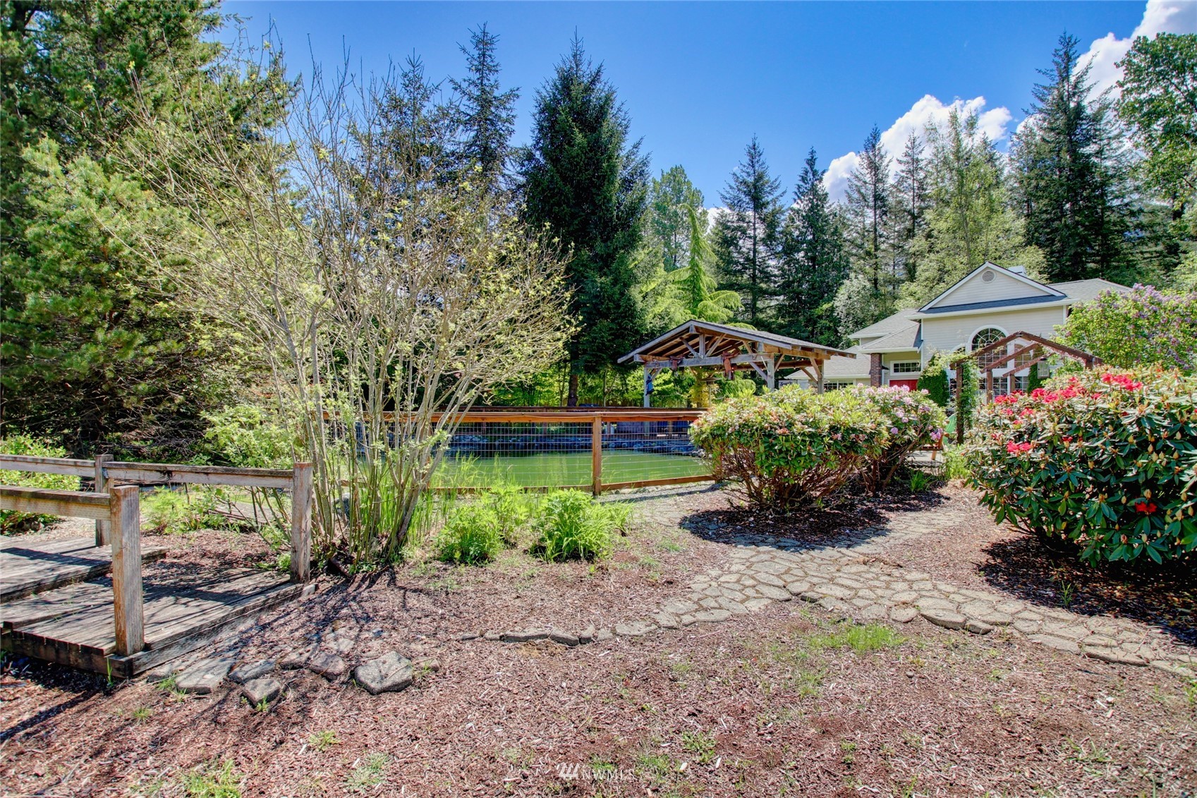 8235 Lusk Road Concrete, WA 98237 - Photo 13 of 40 a front view of a house with a yard and a garden