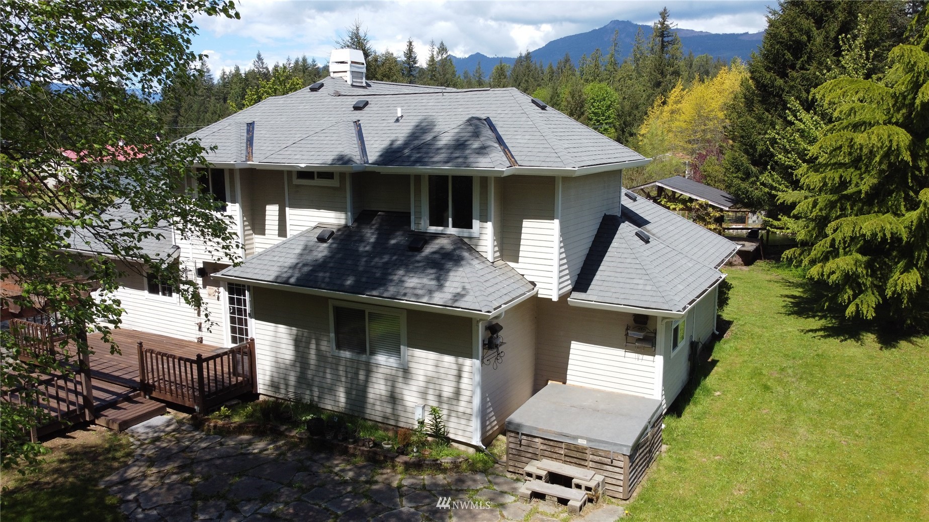 8235 Lusk Road Concrete, WA 98237 - Photo 2 of 40 a aerial view of a house with swimming pool and sitting area