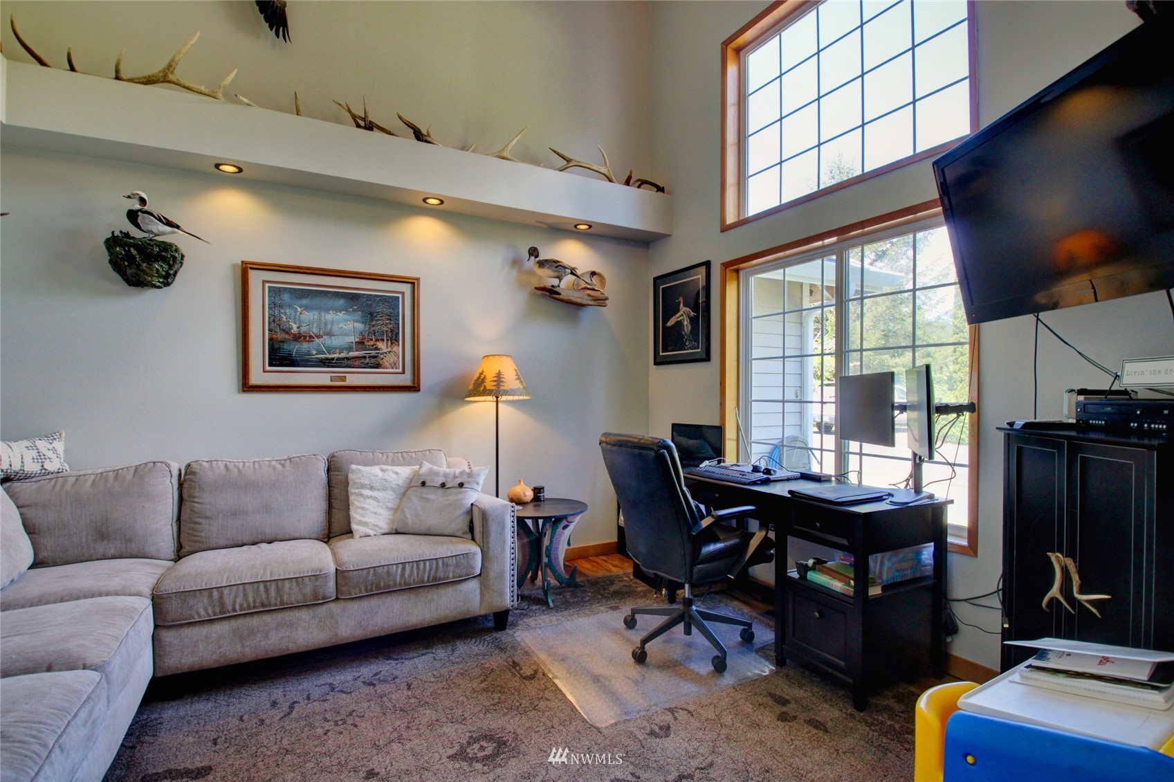 8235 Lusk Road Concrete, WA 98237 - Photo 24 of 40 a living room with furniture a flat screen tv and a window