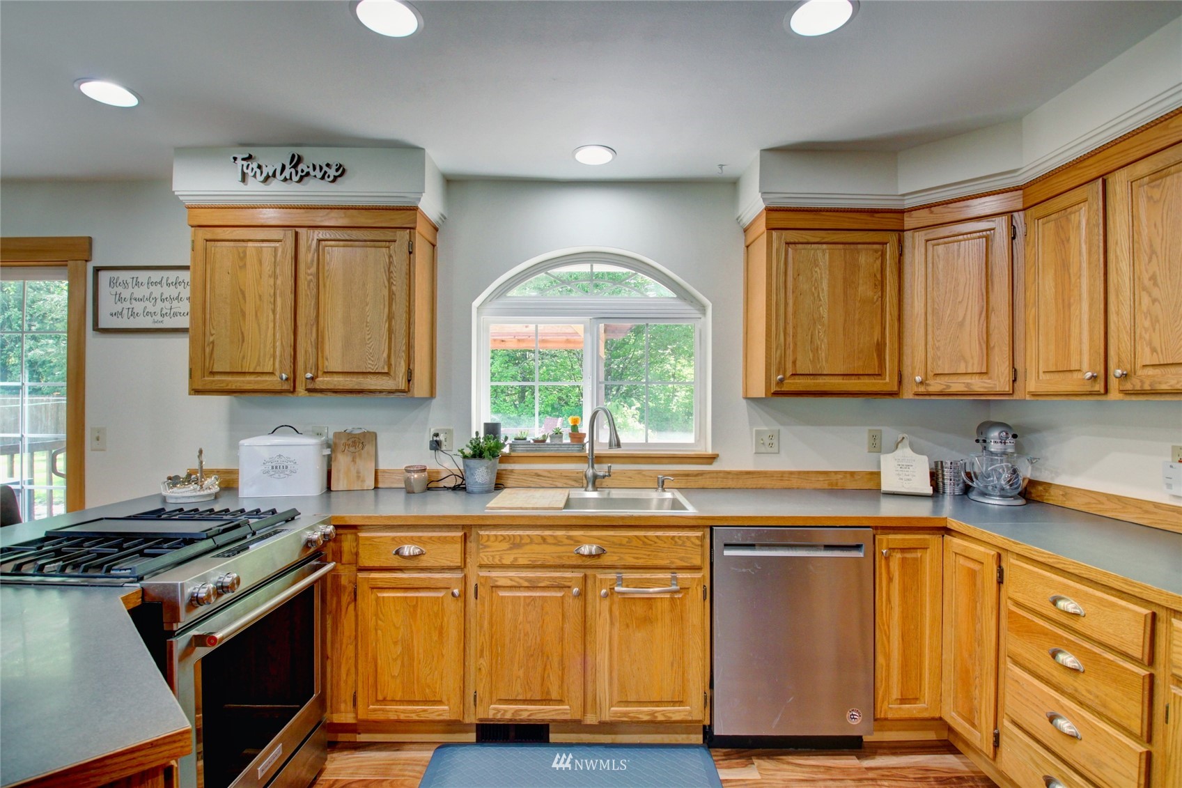 8235 Lusk Road Concrete, WA 98237 - Photo 27 of 40 a kitchen with stainless steel appliances wooden cabinets and a stove top oven