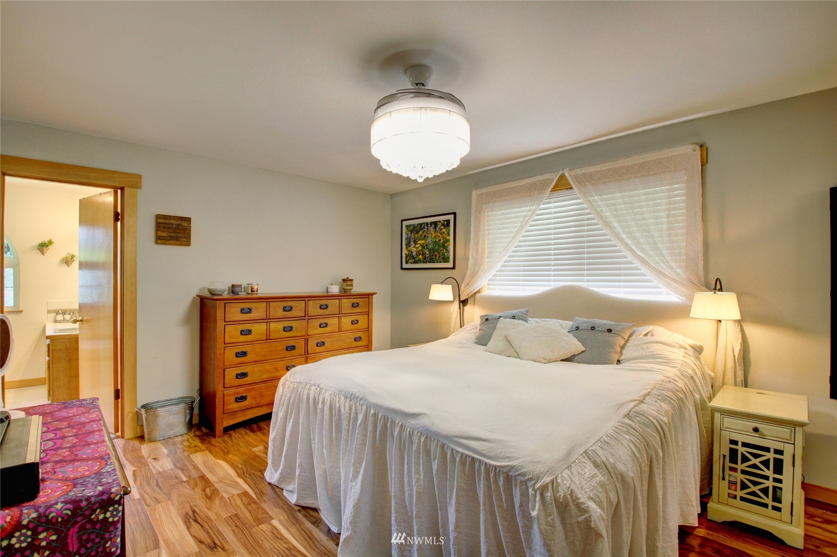 8235 Lusk Road Concrete, WA 98237 - Photo 32 of 40 a bedroom with a bed and wooden floor