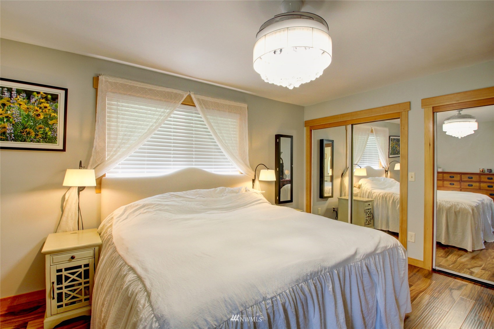 8235 Lusk Road Concrete, WA 98237 - Photo 33 of 40 a bedroom with a bed and a chandelier