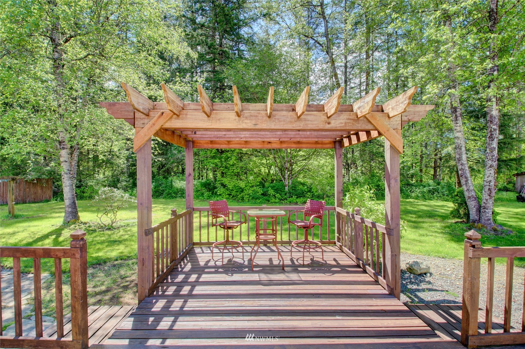 8235 Lusk Road Concrete, WA 98237 - Photo 8 of 40 a view of a patio with table and chairs potted plants and large tree