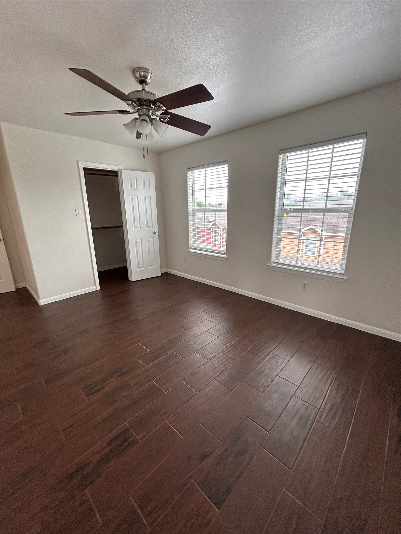 6837 Larkstone Street, Unit A Houston, TX 77028 - Photo 11 of 18 an empty room with wooden floor fan and windows