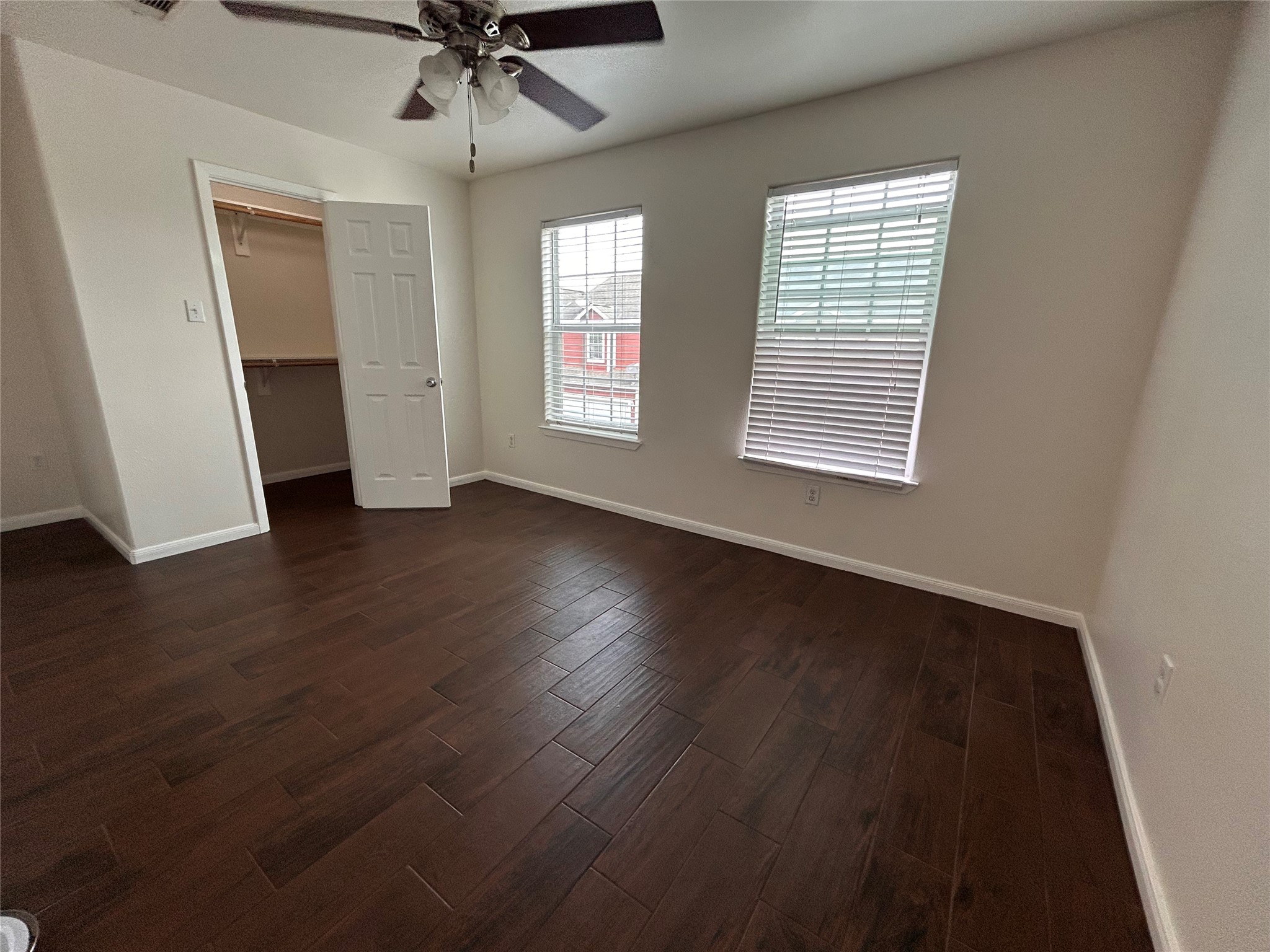 6837 Larkstone Street, Unit A Houston, TX 77028 - Photo 15 of 18 an empty room with wooden floor fan and windows
