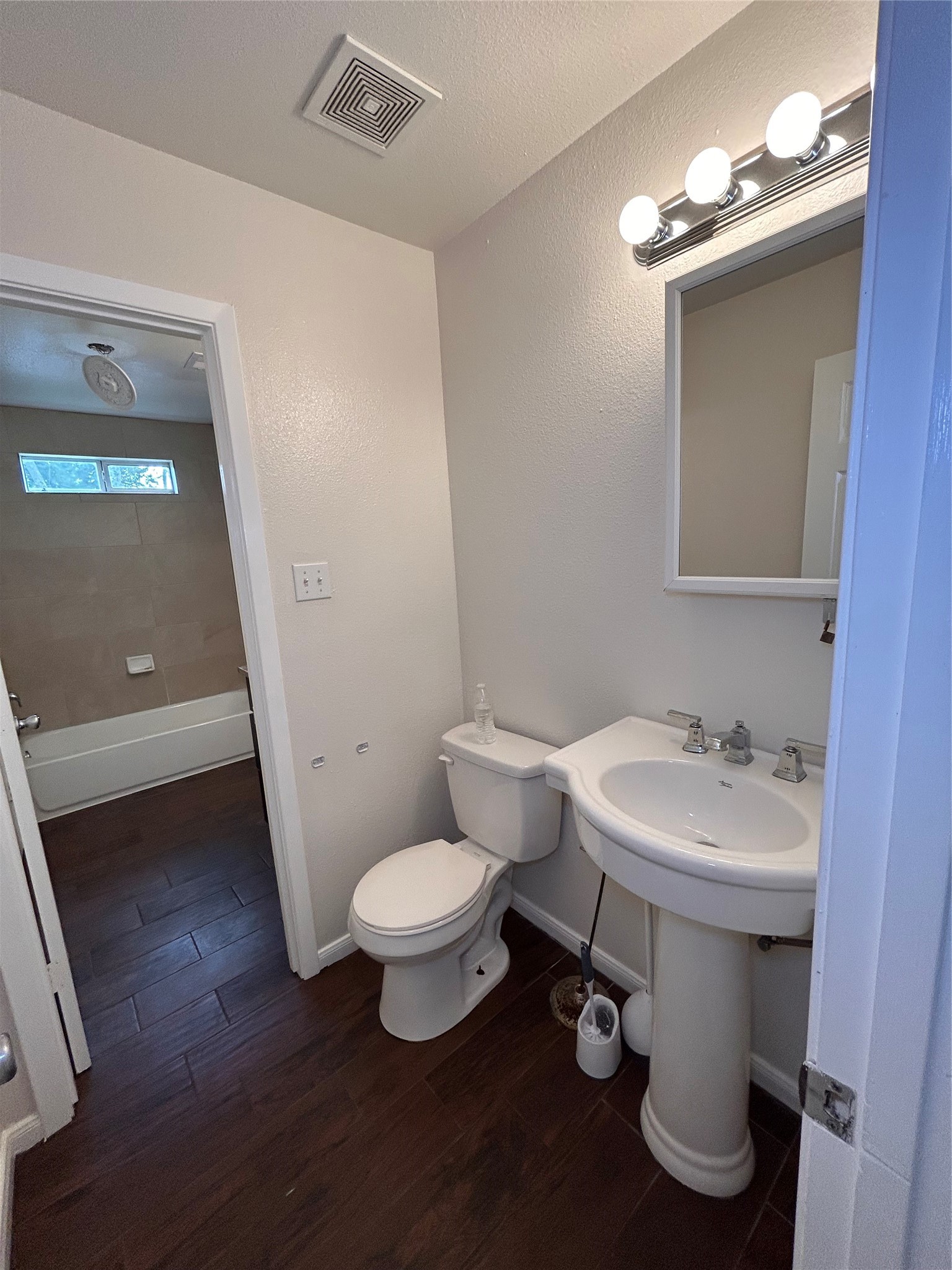 6837 Larkstone Street, Unit A Houston, TX 77028 - Photo 17 of 18 a bathroom with a sink toilet and a mirror