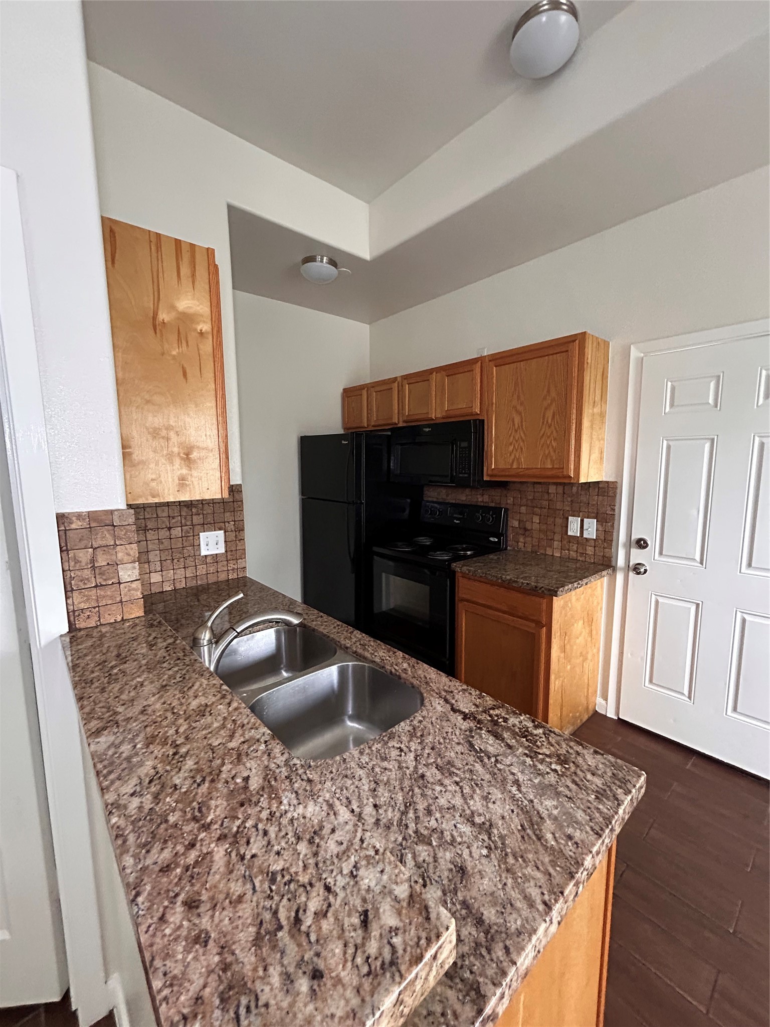 6837 Larkstone Street, Unit A Houston, TX 77028 - Photo 3 of 18 a kitchen with a sink a stove and refrigerator