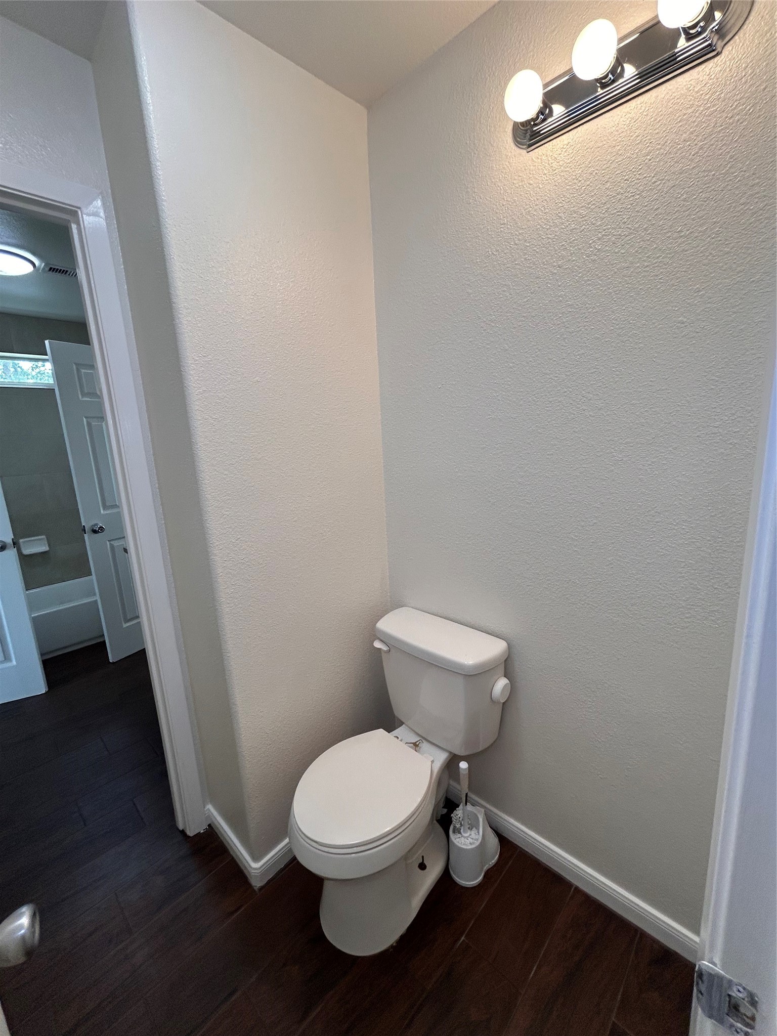 6837 Larkstone Street, Unit A Houston, TX 77028 - Photo 9 of 18 a white toilet sitting next to a sink