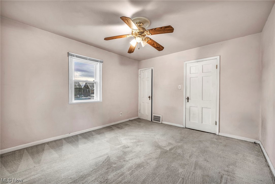 3946 Lansdale Road Cleveland, OH 44118 - Photo 31 of 42 Bedroom featuring light carpet, ceiling fan, and two closets