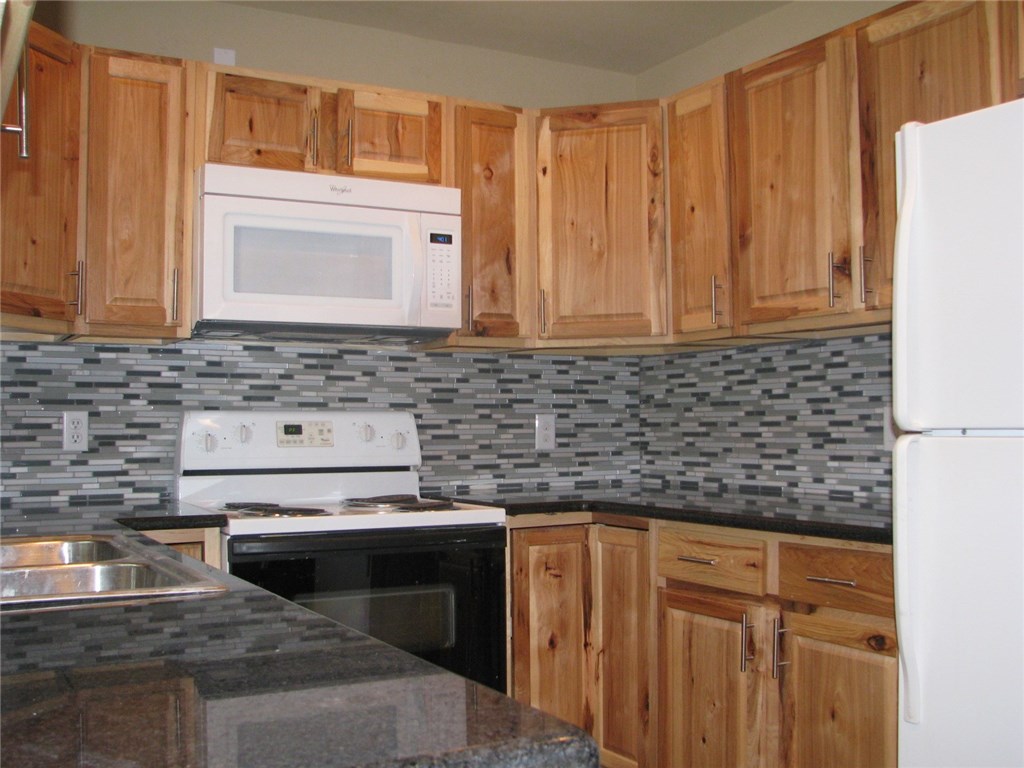 2830 San Gabriel Street, Unit B Austin, TX 78705 - Photo 2 of 14 a kitchen with granite countertop a sink stove and cabinets