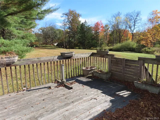 a view of a wooden deck with a yard
