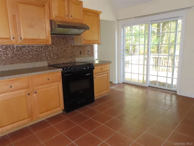 a kitchen with a sink a stove and cabinets