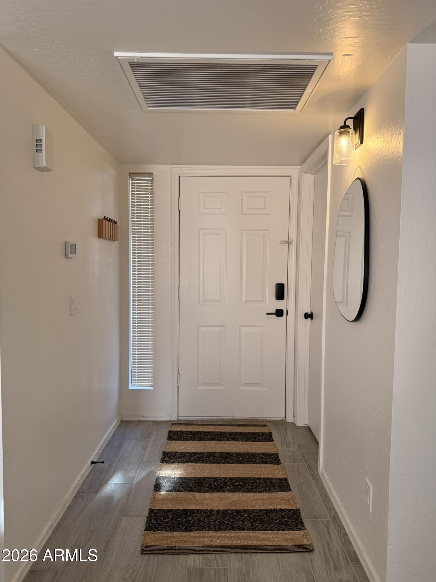 2554 West Kathleen Road Phoenix, AZ 85023 - Photo 5 of 22 a view of a hallway with wooden floor and white walls