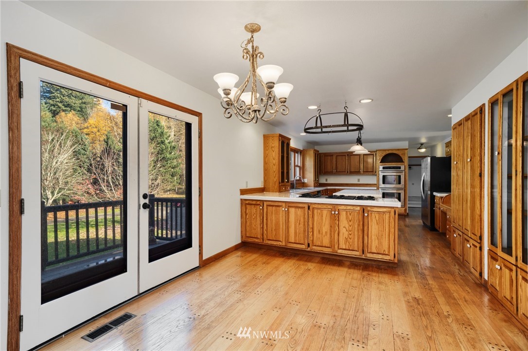 4566 Anderson Way Bellingham, WA 98226 - Photo 24 of 29 a view of a kitchen with a sink refrigerator and wooden floor