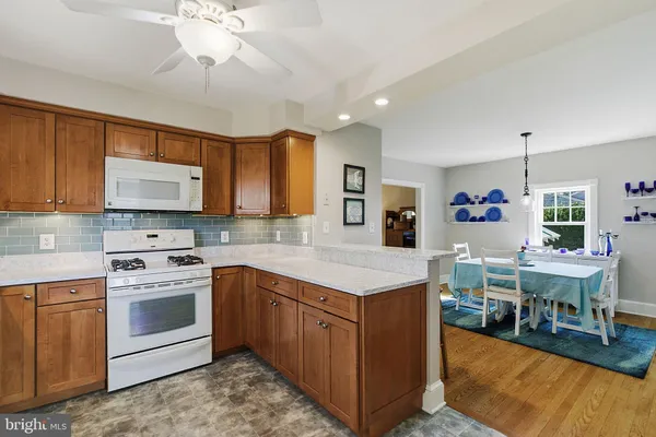 a kitchen with a stove cabinets and wooden floor