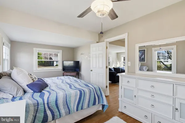 a bedroom with a large bed and a chandelier