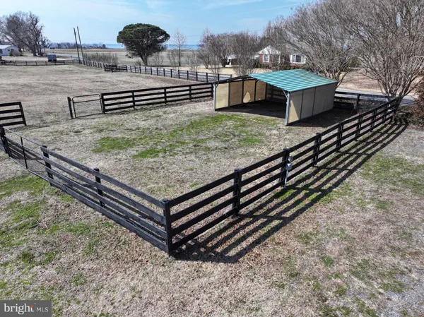a view of a backyard with wooden fence